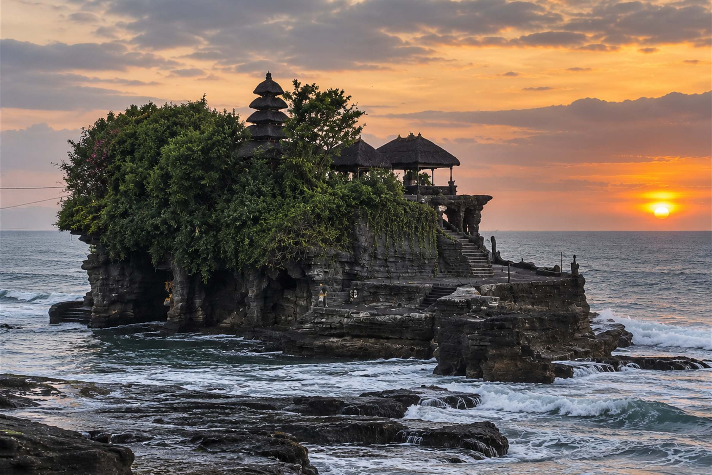 Tanah Lot temple on its rock in the sea at sunset
